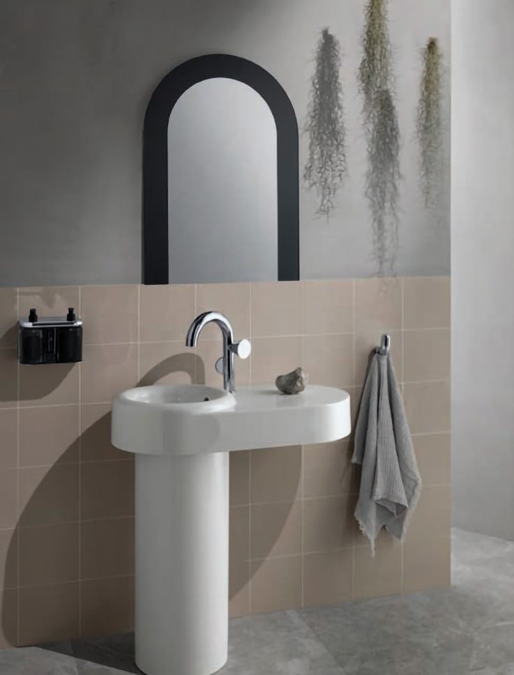 White basin with black framed mirror. 