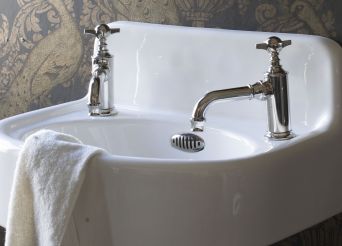 White basin with traditional taps. 