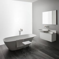 Washbasin, vanity unit, bath tub and frame mirror.