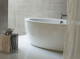 White double-ended freestanding bath and surround. 