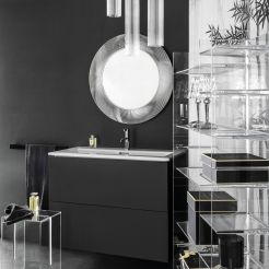 Washbasin with vanity unit, circle mirror, rack, pendant lights and stool. 